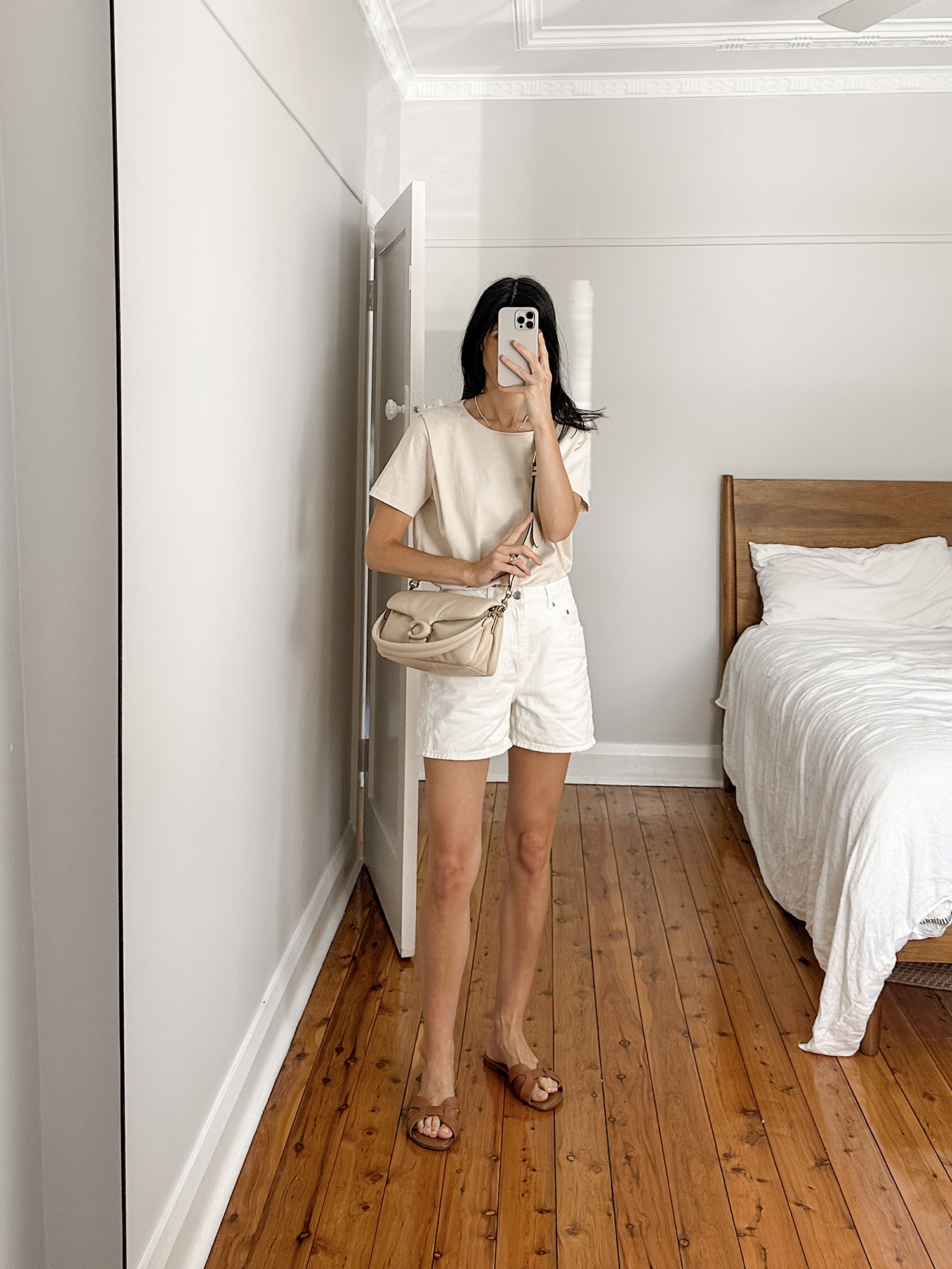 Sezane Paxton t shirt and Arket Denim shorts with Coach pillow tabby bag